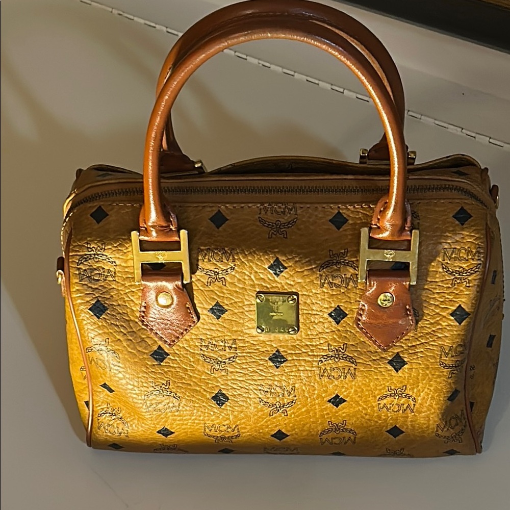 MCM Tan and Black Satchel with Monogram Print
Made in Germany
10.5” wide X  8.5”